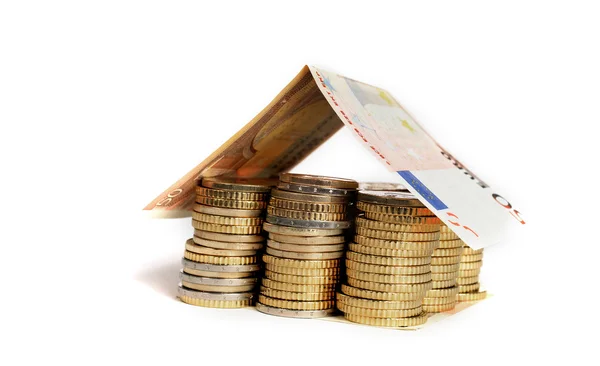 Euro Coins pile House with banknote roof Stock Photo