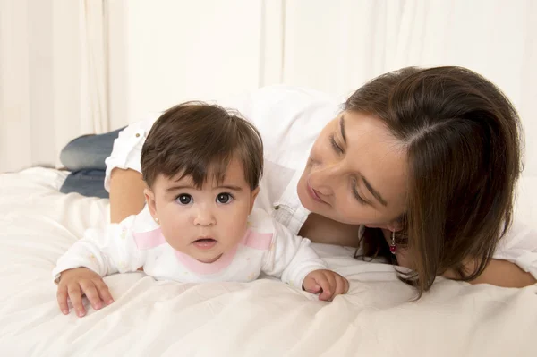 Mother and daughter playing on bed isolated — Stock Photo, Image