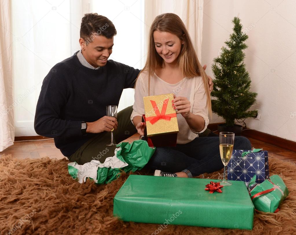 Young Happy Couple opening Xmas presents
