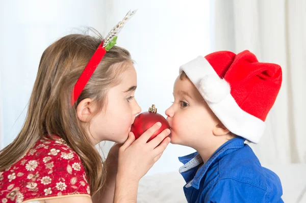 Happy cute little kid and his sister at christmas — Stock Photo, Image