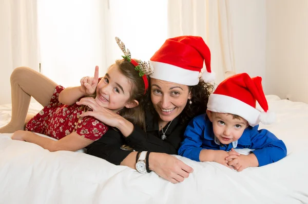 Happy Mum, daughter and little son playing at Christmas — Stock Photo, Image