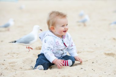 Little Kid on Sand Beach and Seagulls clipart