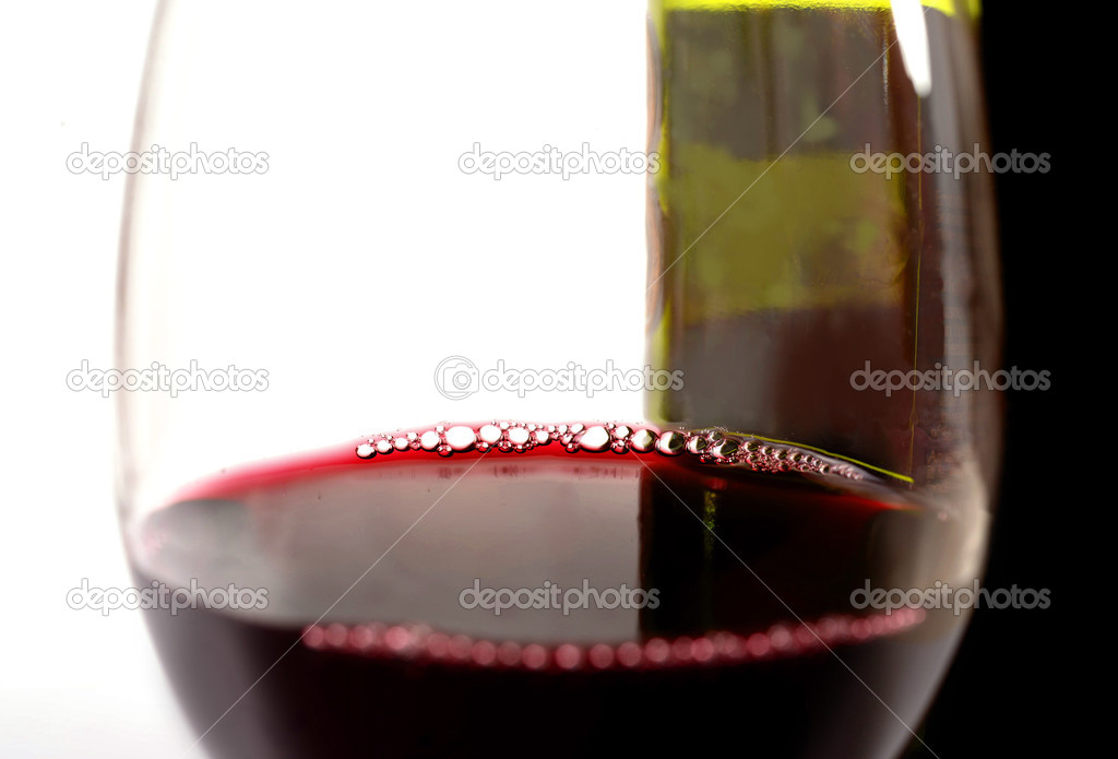 Close Up Glass of Red and Bottle