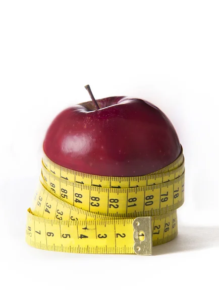 Apple wrapped in tailor tape — Stock Photo, Image