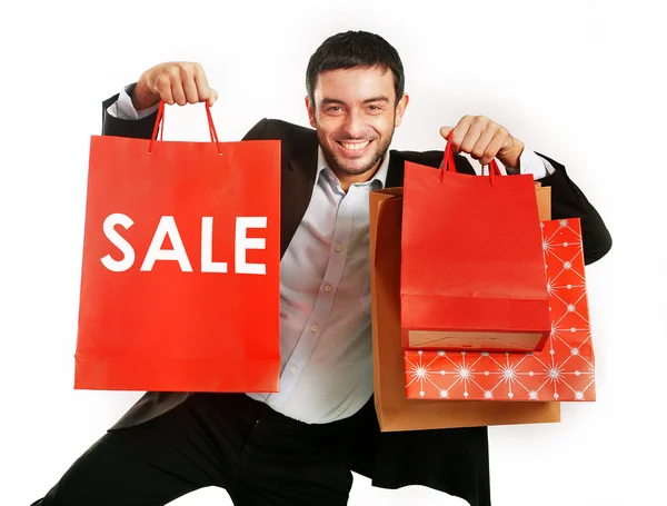 Mężczyzna prowadzenia sprzedaży czerwone torby na zakupy — Zdjęcie stockowe