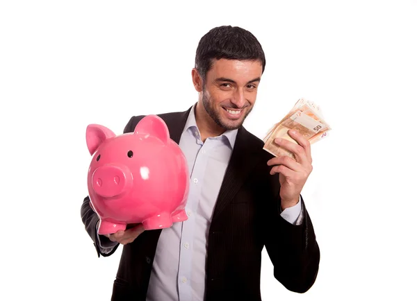 Zakenman roze spaarvarken met geld in de hand houden — Stockfoto