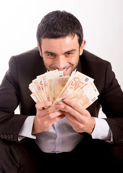 Homem de negócios feliz sentado no porquinho banco contando dinheiro euros — Fotografia de Stock