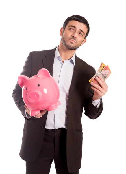 Бизнесмен держит банк с деньгами — стоковое фото