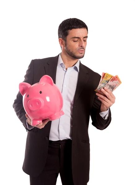 Hombre de negocios sosteniendo alcancía con dinero —  Fotos de Stock