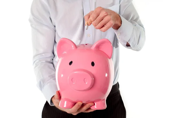 Roze spaarvarken met zakenman op de achtergrond — Stockfoto