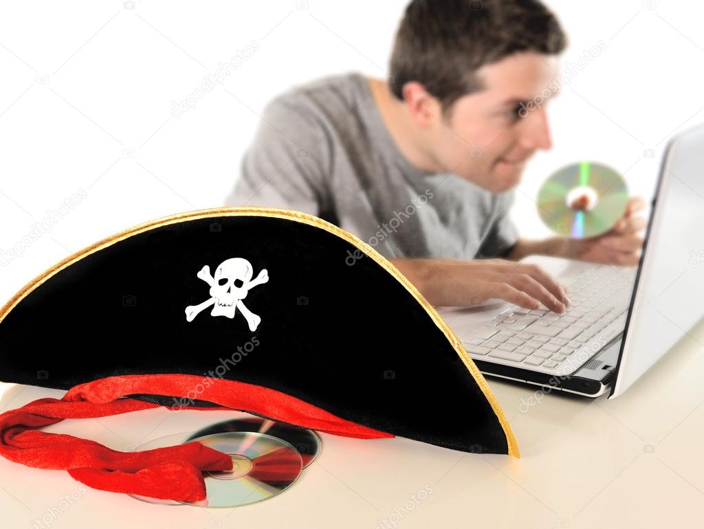 Young man in pirate costume and Computer