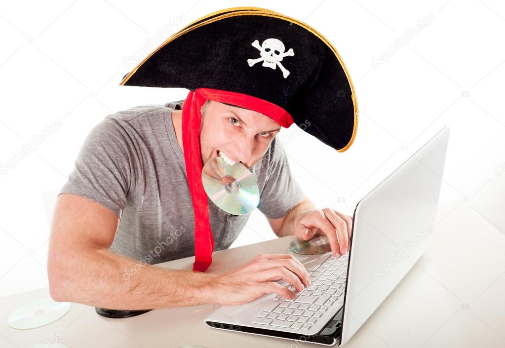 man in pirate hat downloading music on a laptop