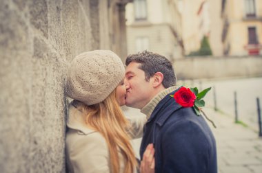 couple with a rose kissing on valentines day clipart