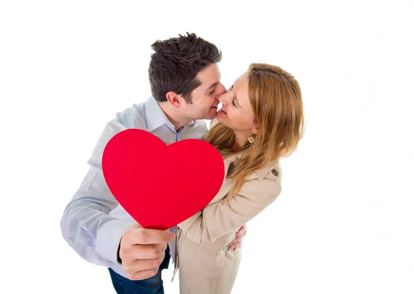 Love heart with a young couple kissing in back ground — Stock Photo, Image