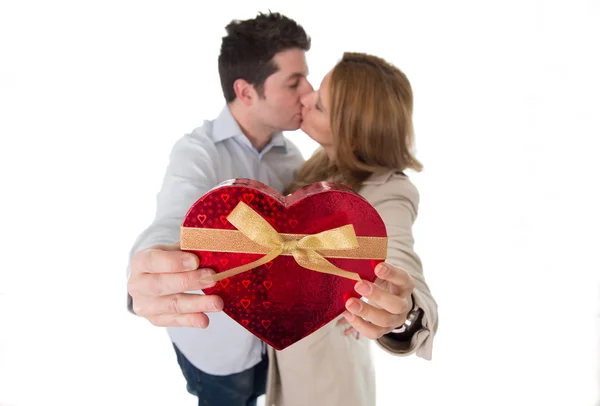 Love heart with a young couple kissing in back ground — Stock Photo, Image