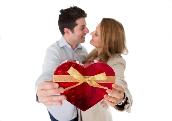 Love heart with a young couple kissing in back ground — Stock Photo, Image