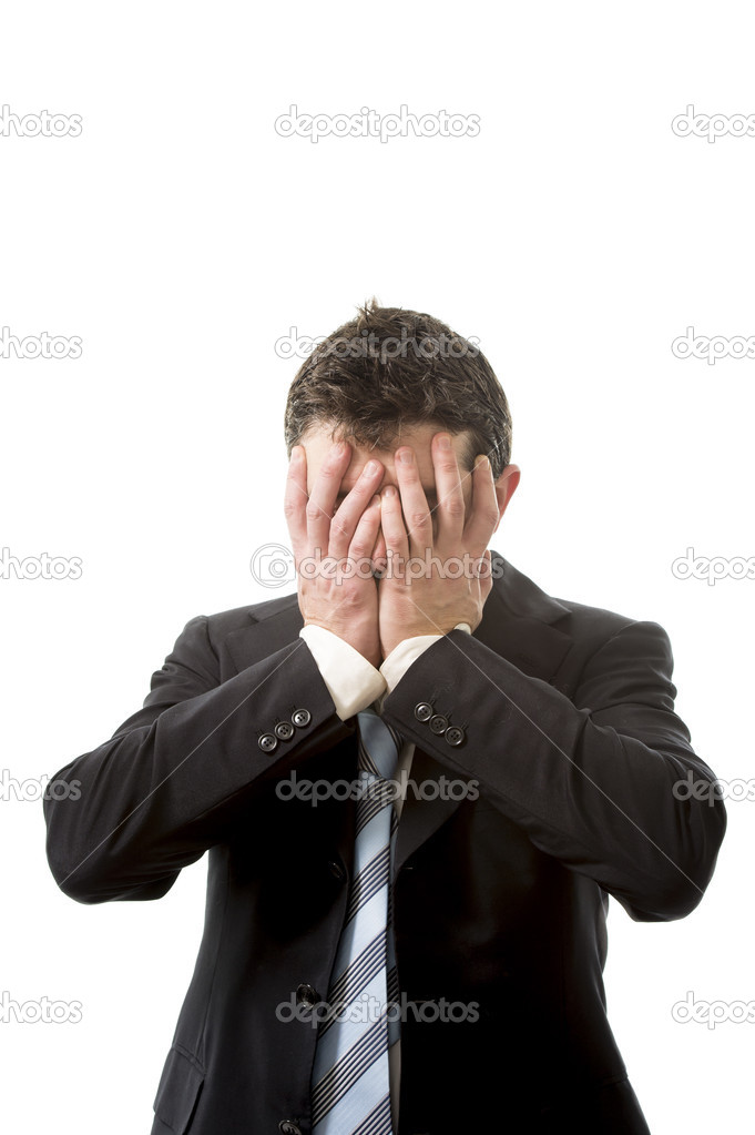 stressed business man covering his face with his hands