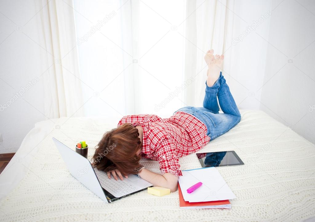 red haired student alseep on laptop while studing