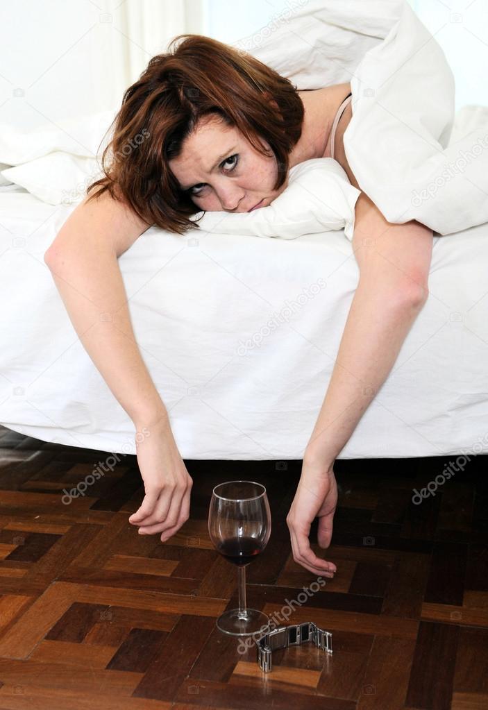 red hair woman with hangover after drinking wine