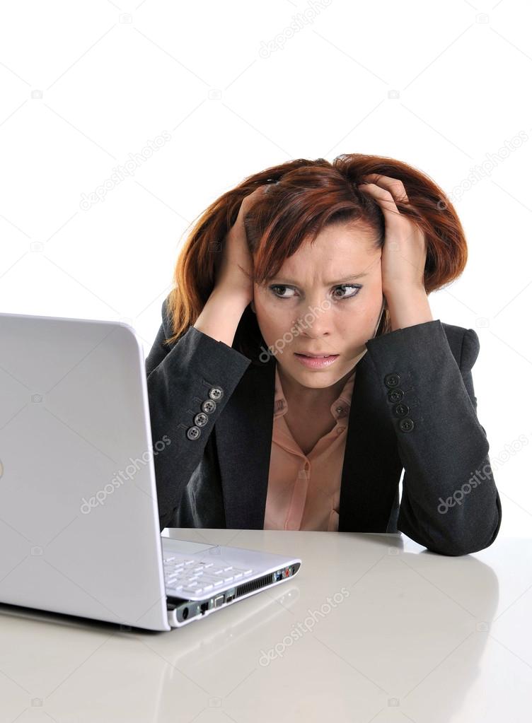 sad business red haired woman in stress at work with computer