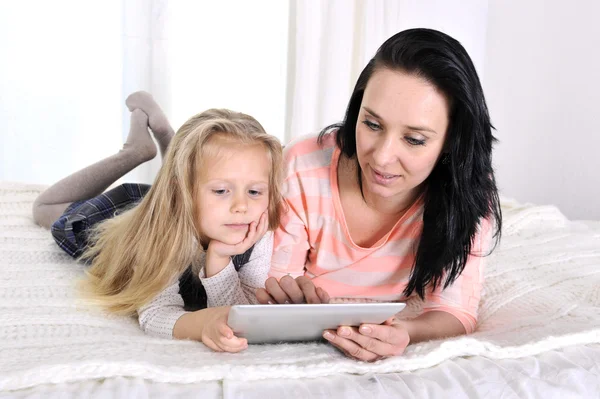 Happy young mother and little adorable blonde daughter with tablet — Stock Photo, Image