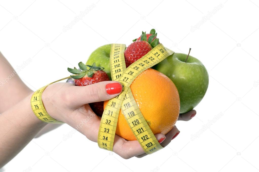 Woman hands with fruit  bond with measure tape slave to diet