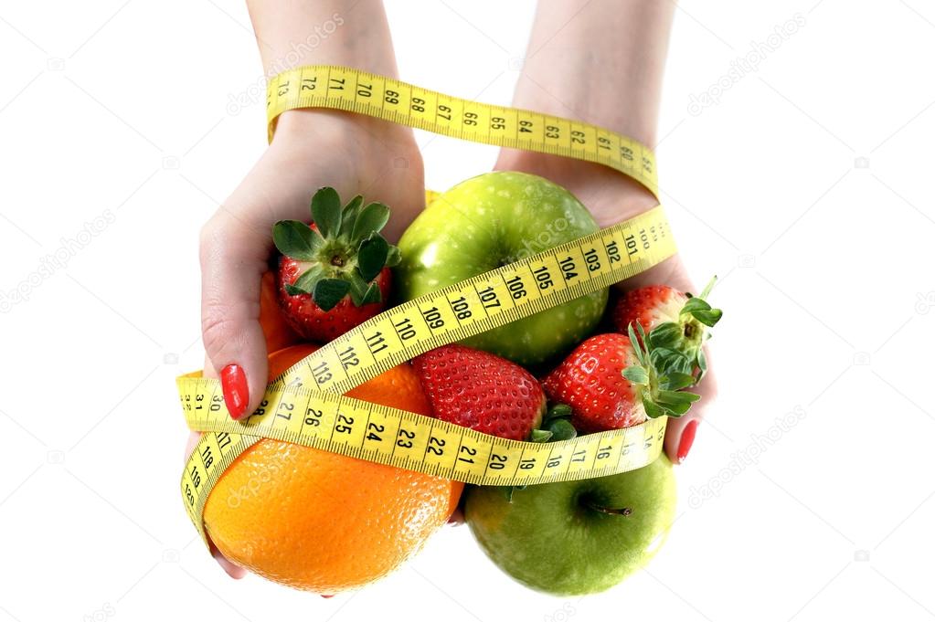 Woman hands with fruit  bond with measuring tape slave to diet