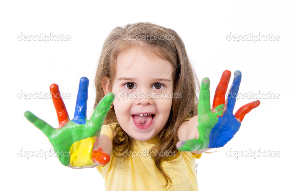 Happy little girl with hands painted in vivid colours