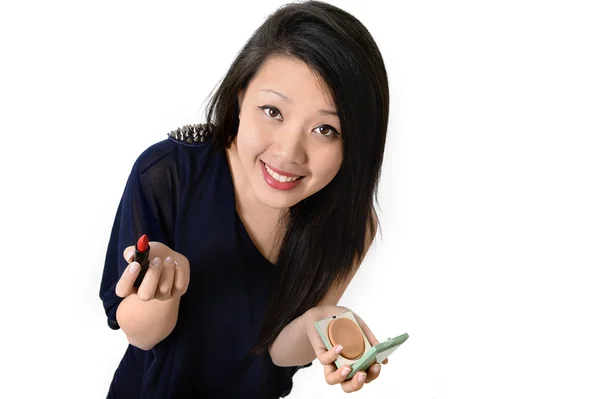 Young beautiful asian american painting her lips red with lipstick — Stock Photo, Image