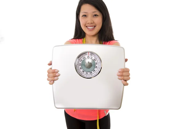 Macrco of a woman holding scales on a white background — Stock Photo, Image