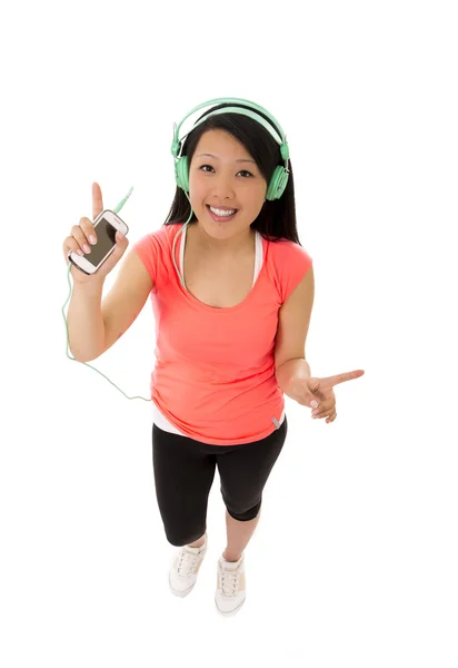 Pretty asian woman listening to music with big headphones on whi — Stock Photo, Image