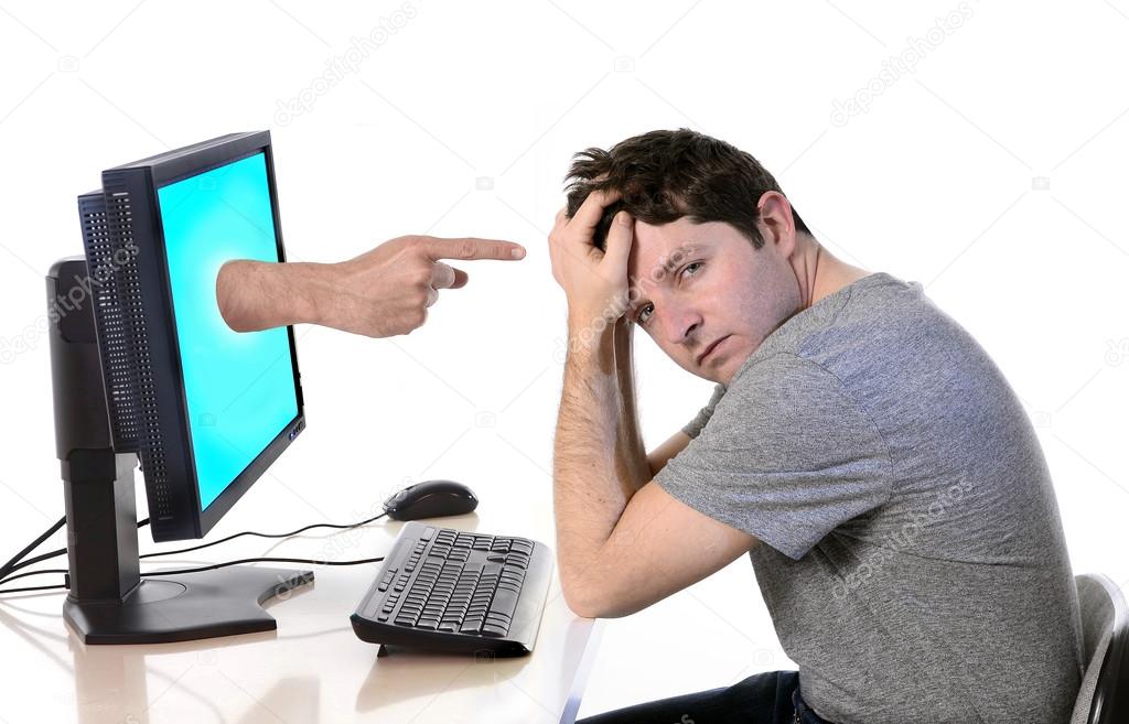 man with computer finger pointing in social media cybermobbing and bullying 