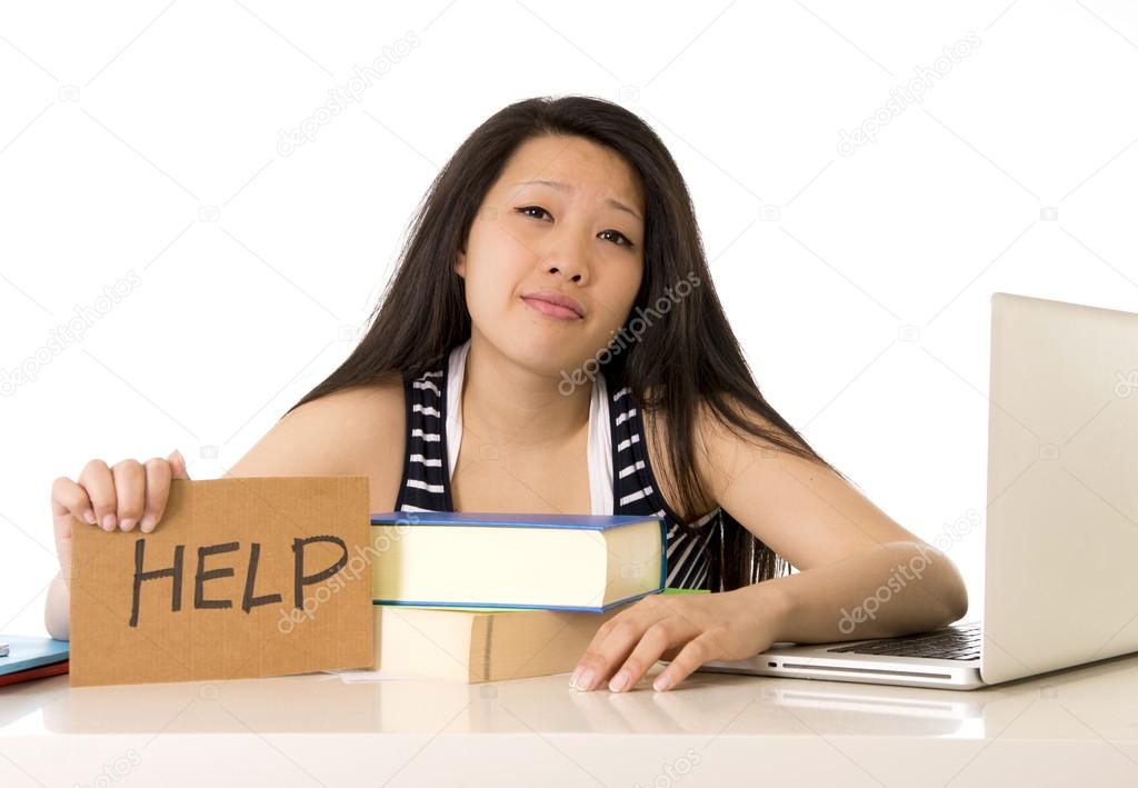 young pretty chinese asian holding a help sign while working on 