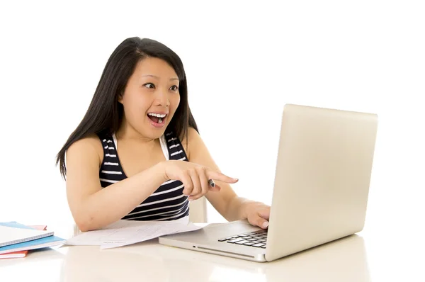 Happy chinese asian woman working pointing at her laptop — Stock Photo, Image