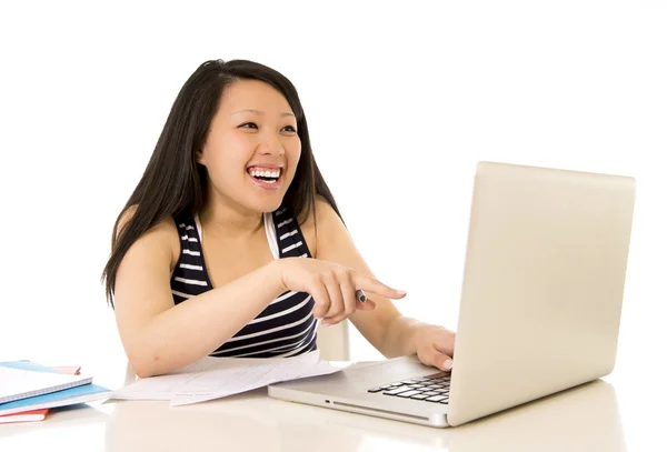 Happy chinese asian woman working pointing at her laptop — Stock Photo, Image