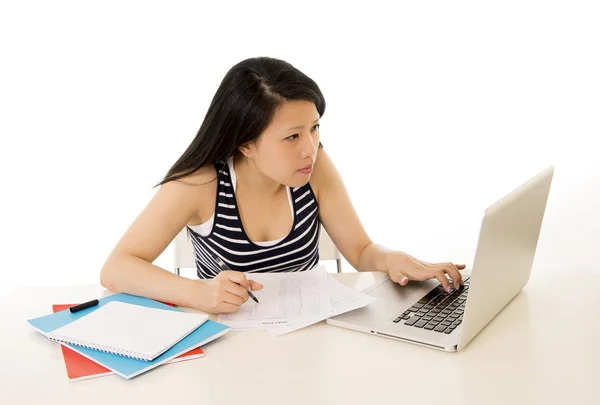 Chinese asian woman working on her laptop on white background — Stock Photo, Image