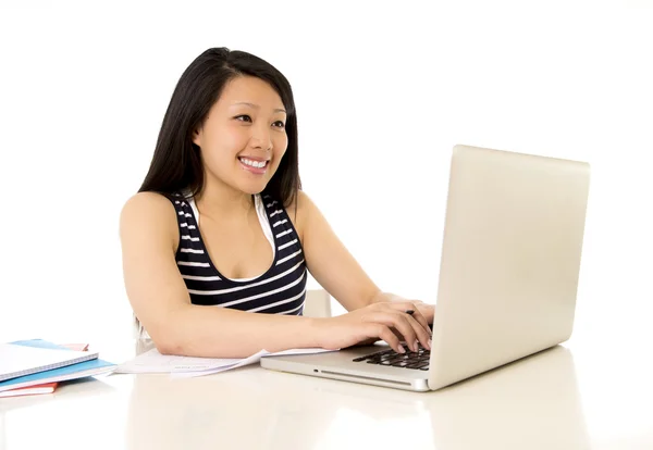 Happy chinese asian woman working on her laptop on white backgro — Stock Photo, Image