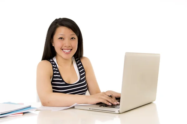 Happy chinese asian woman working on her laptop on white backgro Royalty Free Stock Images