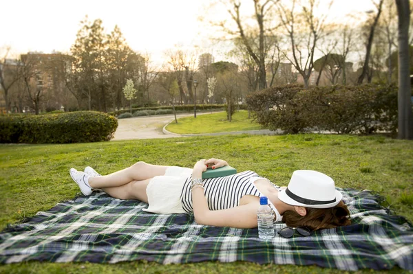 Nő alszik egy kalap arcán egy parkban — Stock Fotó