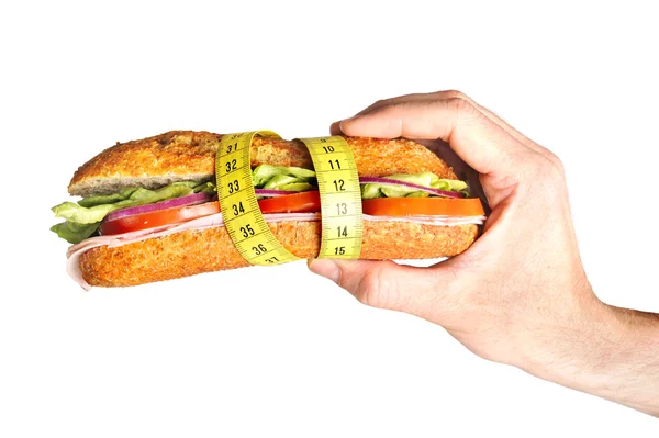 Hand holding Vegetal Sandwich wrapped in measure tape in diet concept — Stock Photo, Image