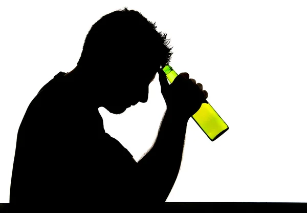 Silhouette of alcoholic drunk man drinking beer bottle feeling depressed suffering alcoholism and addiction problem — Stock Photo, Image