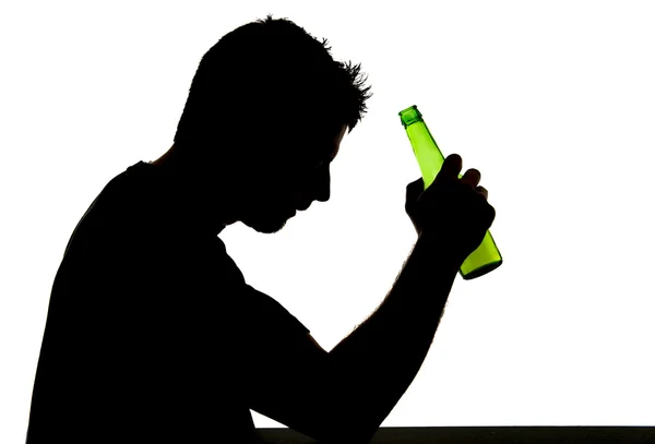 Silhouette of alcoholic drunk man drinking beer bottle feeling depressed falling into addiction problem — Stock Photo, Image