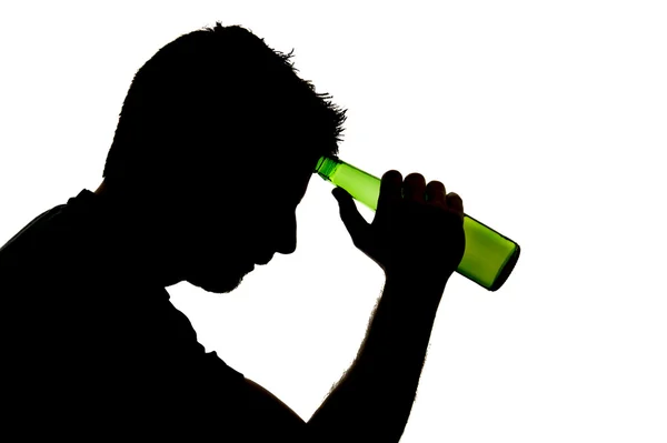 Silhouette of alcoholic drunk man drinking beer bottle feeling sad and depressed in alcohol addiction problem — Stock Photo, Image