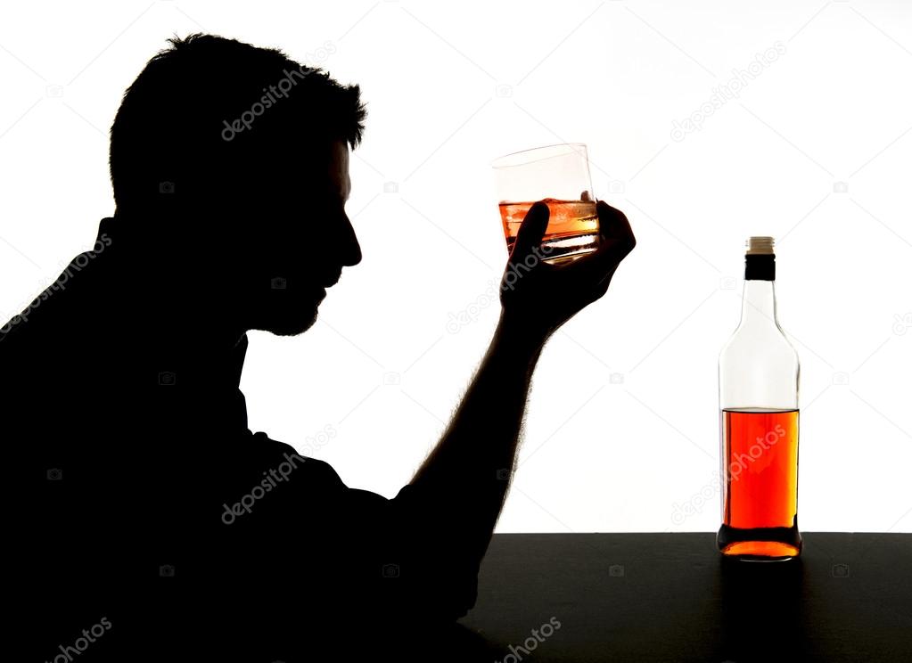 silhouette of alcoholic drunk man drinking whiskey bottle feeling depressed falling into addiction problem