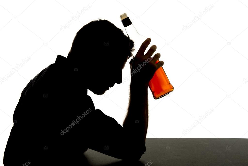 silhouette of alcoholic drunk man drinking whiskey bottle feeling depressed falling into addiction problem