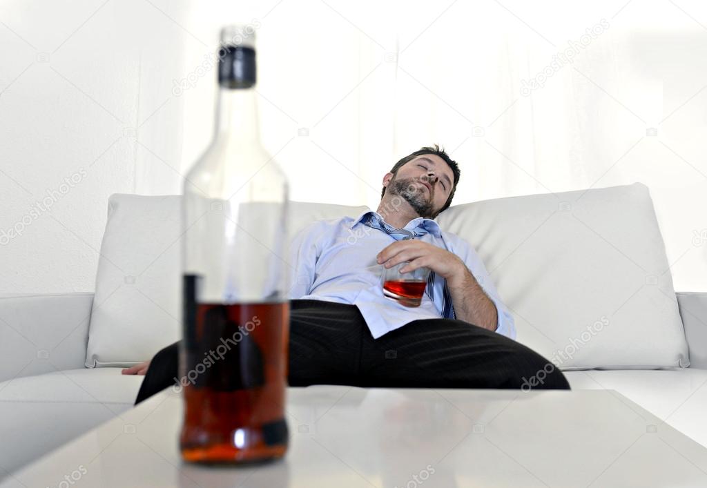 drunk business man wasted and whiskey bottle in alcoholism