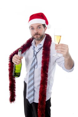 drunk businessman drinking champagne wearing a santa hat on white background clipart