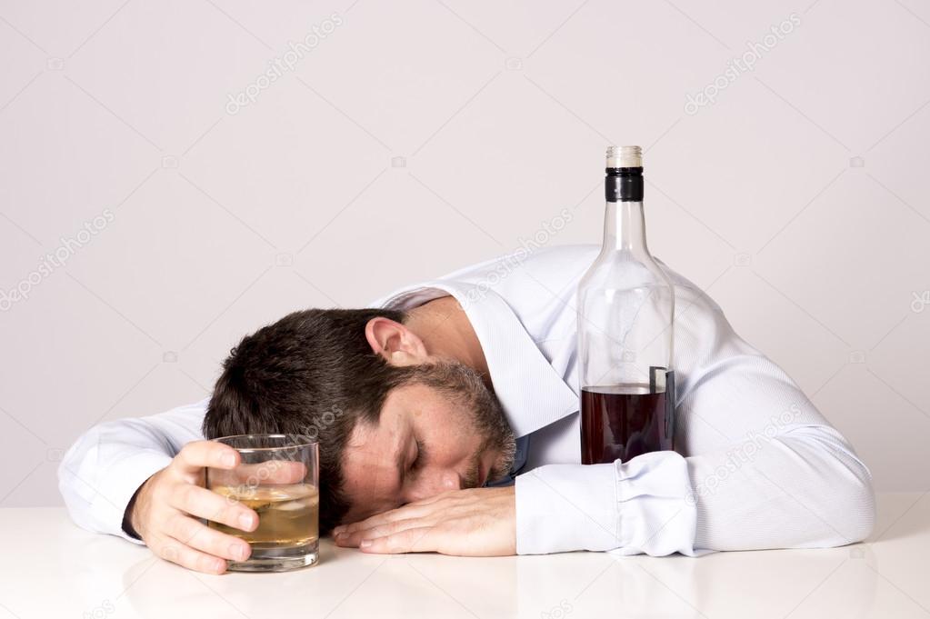 Businessman wearing blue shirt drunk at desk on clear background