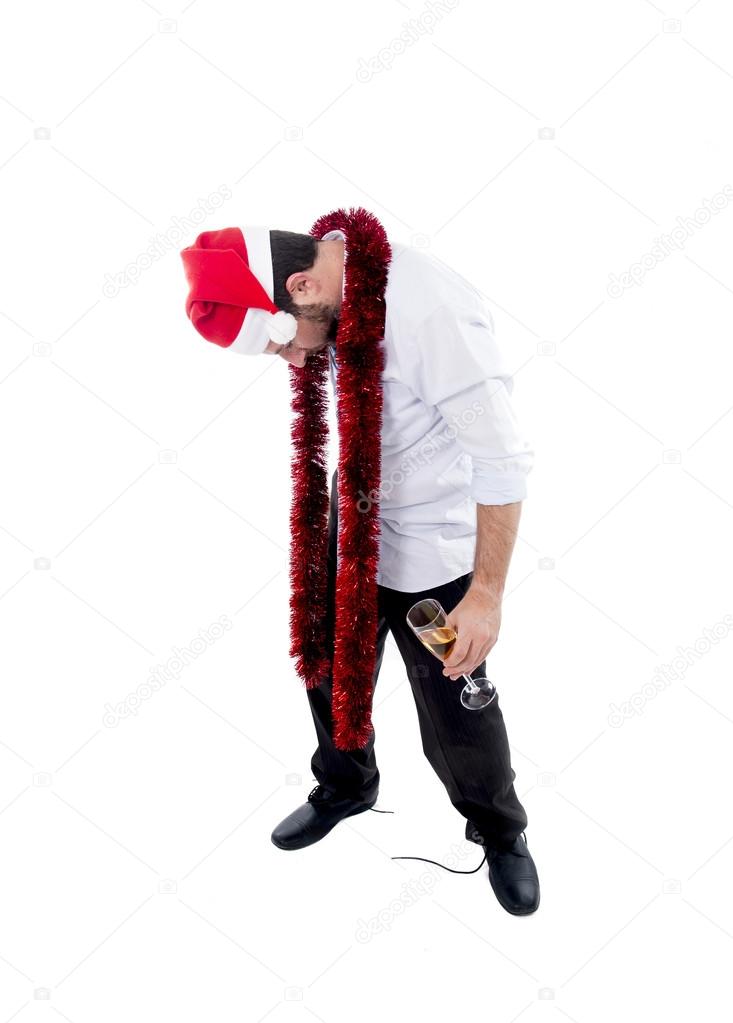 drunk businessman drinking champagne wearing a santa hat on whit