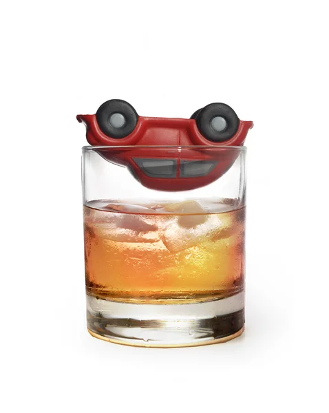 Toy car on glass of whiskey as traffic accident due to alcohol — Stock Photo, Image